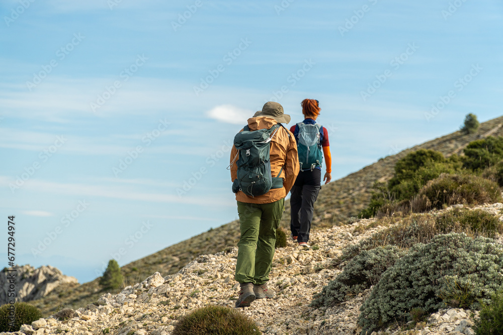 Two mountaineers walking towards the top of the mountain