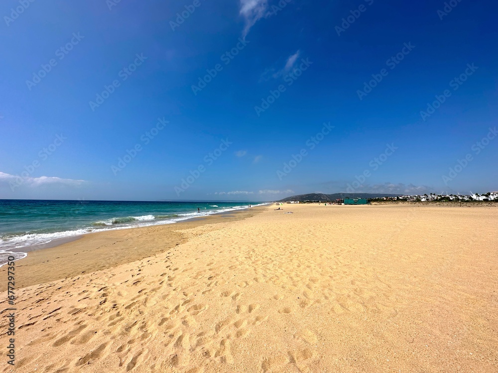 beach at the Atlantic Ocean in Zahara de los Atunes with.a view towards Barbate at the horizon on a summer day, Playa del Cabo de la Plata, Costa de la Luz, Andalusia, Cadiz, Province, Spain beach at the Atlantic Ocean in Zahara de los Atunes with.a view towards Barbate at the horizon on a summer day, Playa del Cabo de la Plata, Costa de la Luz, Andalusia, Cadiz, Province, Spain