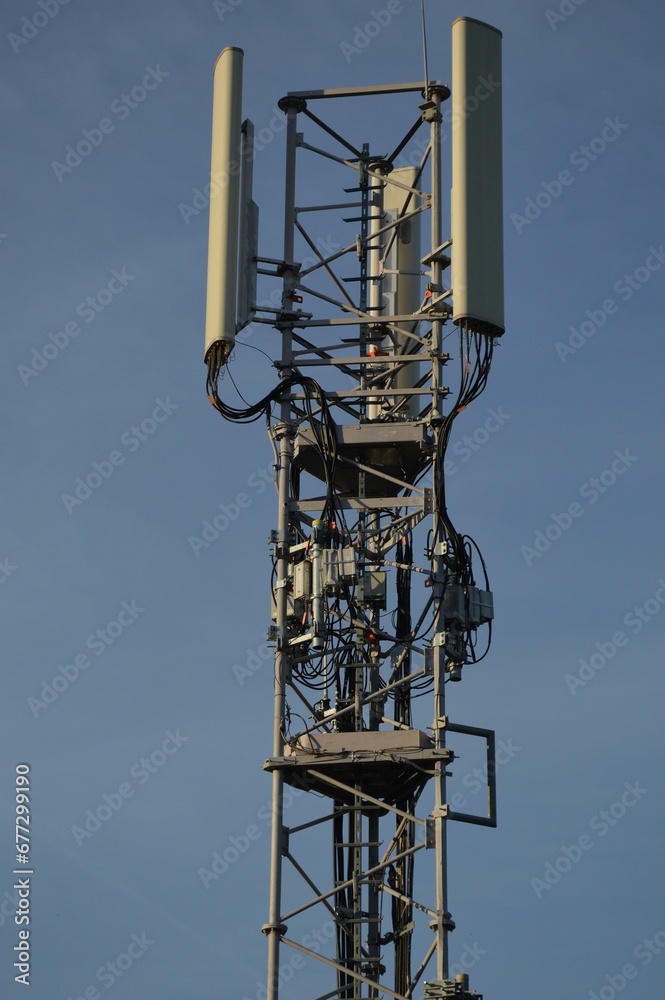 Vertical shot of a wireless communication antenna against a blue sky Vertical shot of a wireless communication antenna against a blue sky