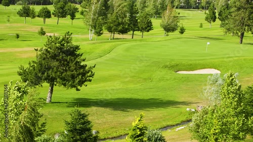 Landscape and golf course with with trees and strong winds.