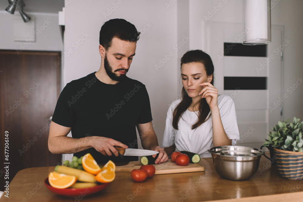 male and female discussing healthy food while cooking at home counter top