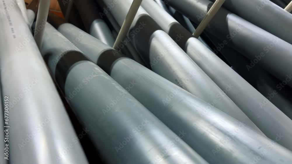 Plastic sewer pipes stacked in a hardware or plumbing store Plastic sewer pipes stacked in a hardware or plumbing store