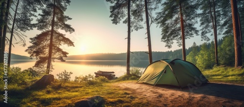 Camping under pine trees near a sunny lake in the morning Copy space image Place for adding text or design photo