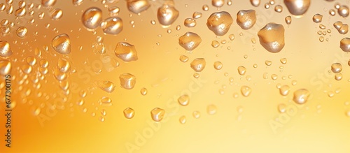 Close up macro shot of water drops on a golden background emphasizing condensation on a cold pint of beer Copy space image Place for adding text or design photo