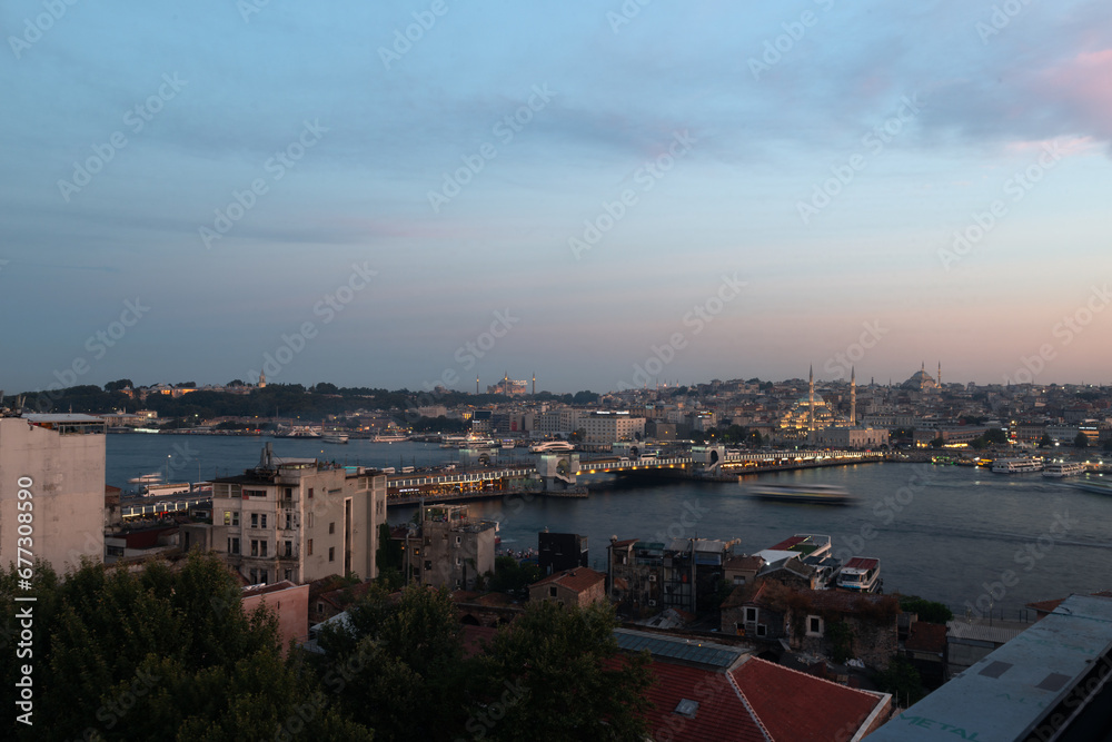Beautiful view of Istanbul's historical peninsula skyline with the Topkapı Palace, Hagia Sofia, the New Mosque and Galata Bridge shot during early evening