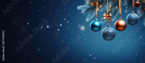 Blue abstract night with gift boxes hanging from a fir branch in a bauble encased Christmas tree Copy space image Place for adding text or design