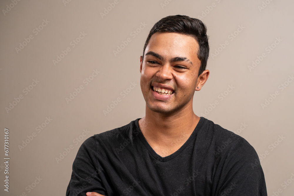 Young man with oriental features smiling on pastel background. Young man with oriental features smiling on pastel background.