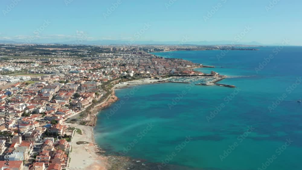 Coastline in Spain. Beach and buildings along seashore. Summer vacation paradise Coastline in Spain. Beach and buildings along seashore. Summer vacation paradise
