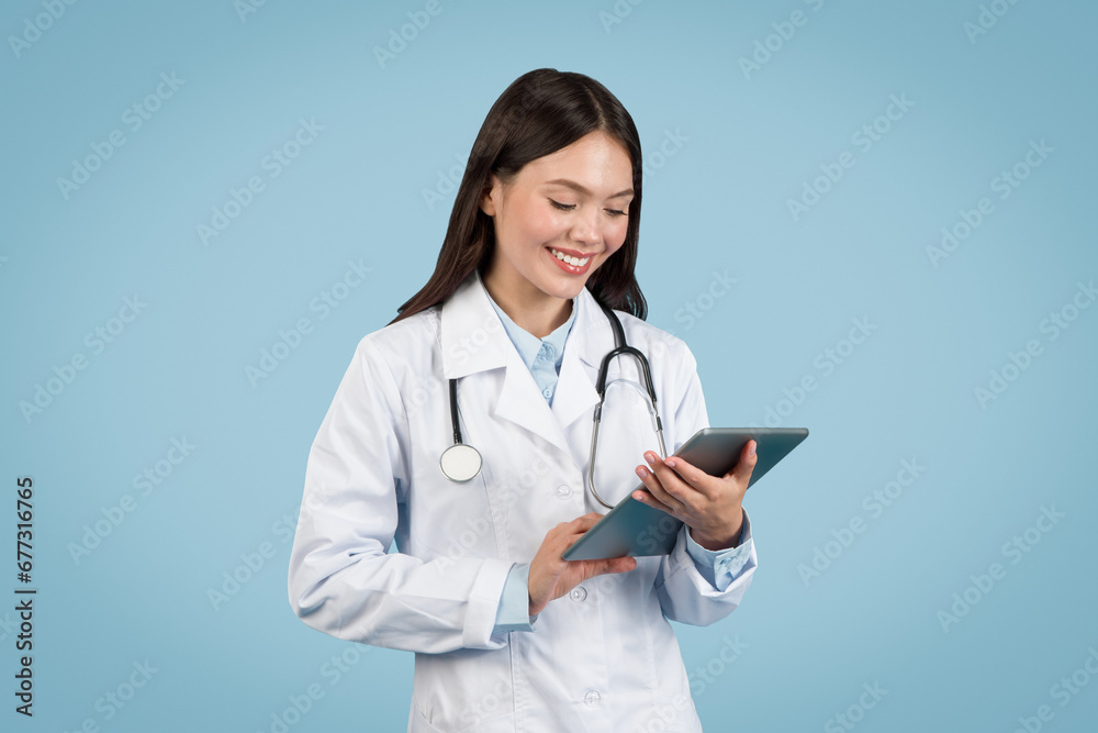 Young female doctor using digital tablet, smiling Young female doctor using digital tablet, smiling