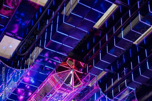 The neon steampunk light in interior of a modern building with an glass elevator