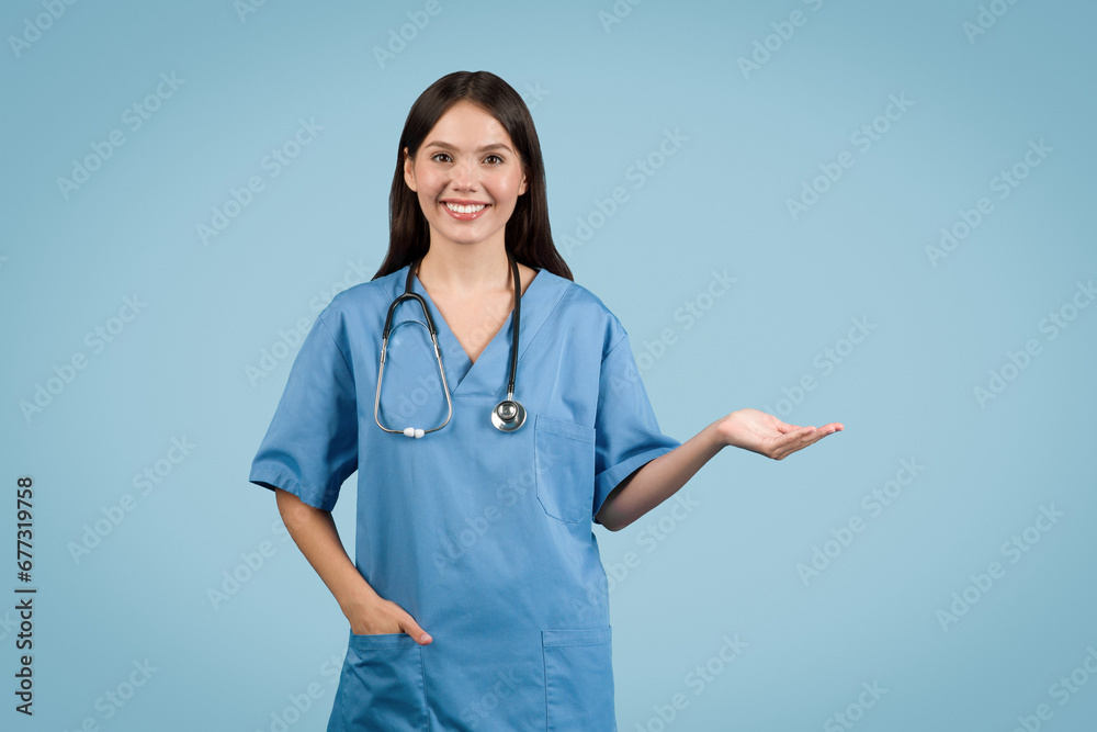 Nurse presenting with hand, smiling at camera, free space Nurse presenting with hand, smiling at camera, free space