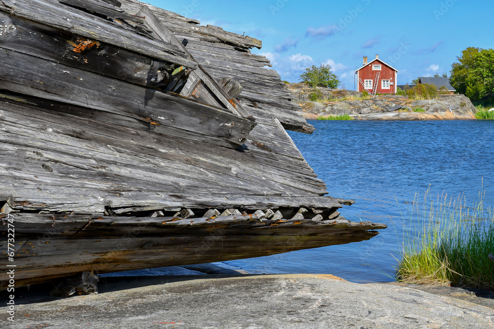 Landscape in the Finnish archipelago with a boat wreck ashore