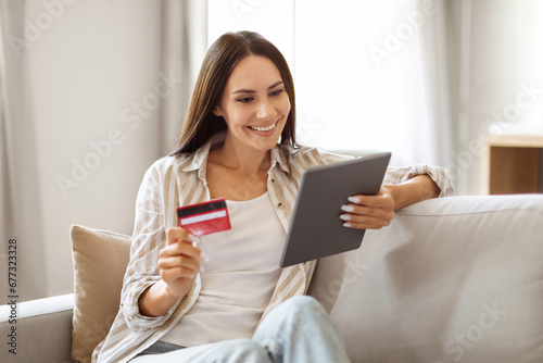 Online Shopping Concept. Smiling Beautiful Female Using Digital Tablet And Credit Card