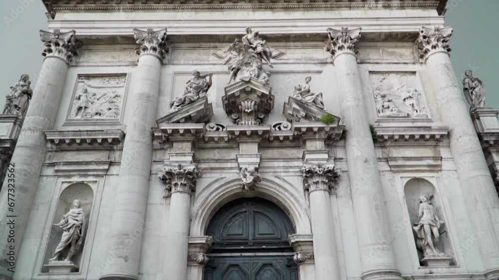 Facade of a cathedral with sculptures, carvings and a black door in Venice, Italy Facade of a cathedral with sculptures, carvings and a black door in Venice, Italy