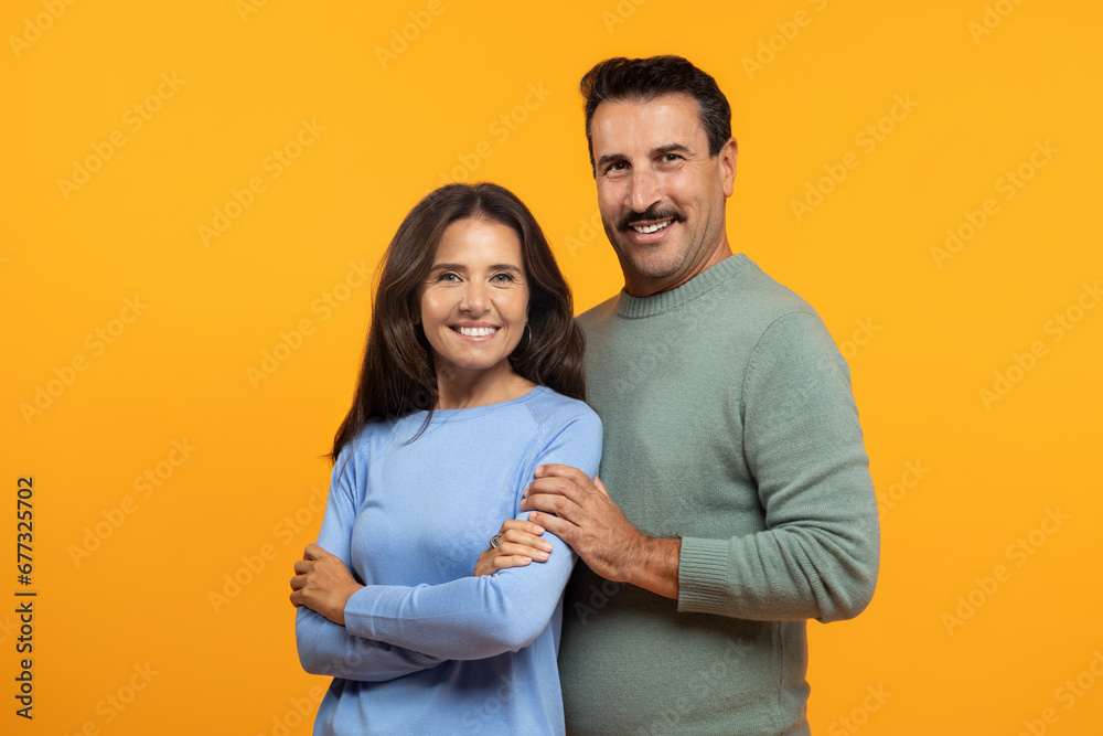 Smiling senior caucasian man and lady hug, look at camera, enjoy spare time together Smiling senior caucasian man and lady hug, look at camera, enjoy spare time together