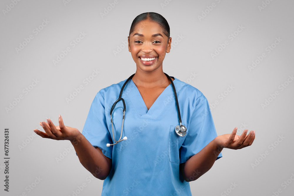 Positive millennial black doctor surgeon, nurse in blue uniform, spread hands to sides Positive millennial black doctor surgeon, nurse in blue uniform, spread hands to sides