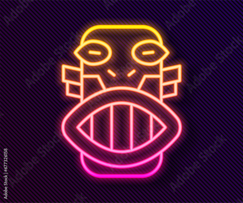 Glowing neon line Mexican mayan or aztec mask icon isolated on black background. Vector