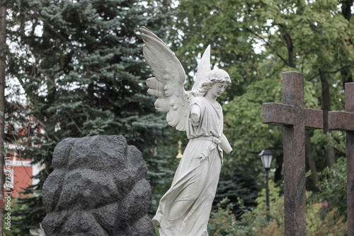 Sad antique statue in a cemetery