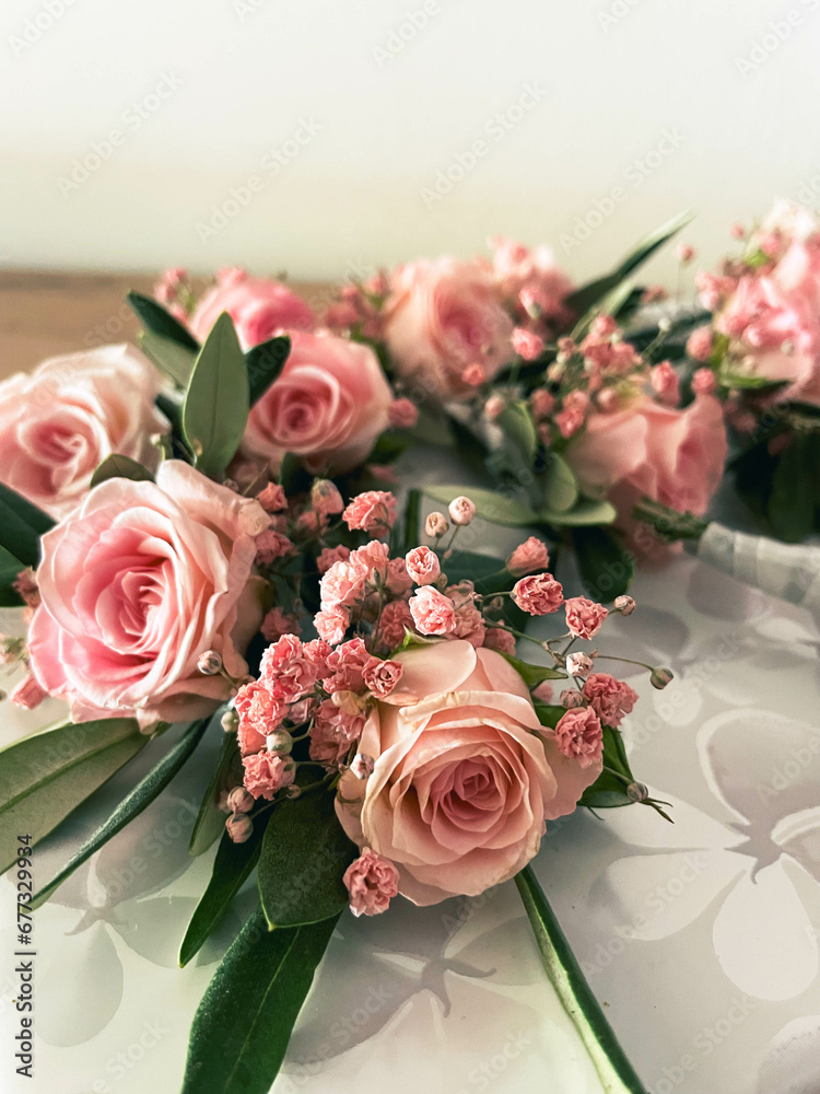 Obraz premium A wedding bouquet of pink roses and pink baby's breath with olive branches and leaves