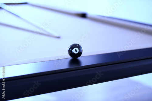Close up of black billiard ball number eight on a pool table