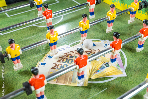Sports and money. Table football game, Concept about money spending in football soccer, sports betting and manipulated fixed matches. photo