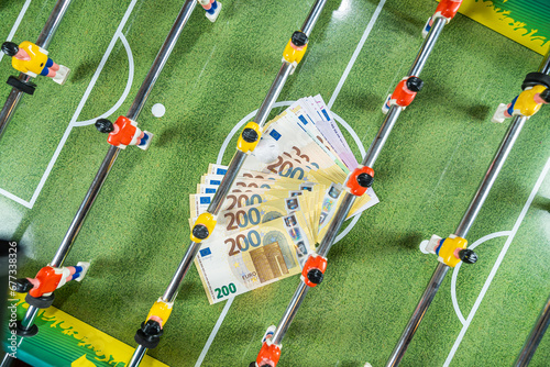 Figures of football players on euro banknotes, top view