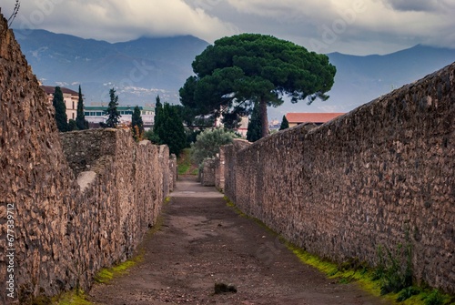 Empty street in Pompeii ruins on a sunny day in Italy photo