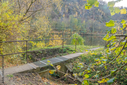 Small wooden iron pedestrian bridge to the river Berunka in Hlasna Treban, czech photo