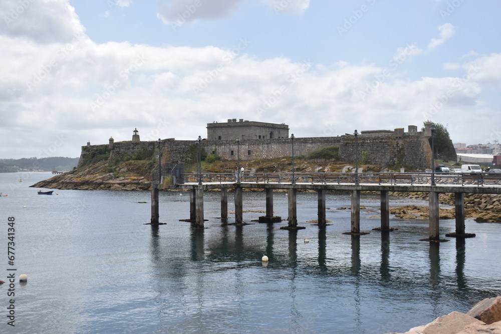 views of the castle of san anton in la coruña, spain. Blue sky with clouds and part of the sea and pier. nature.