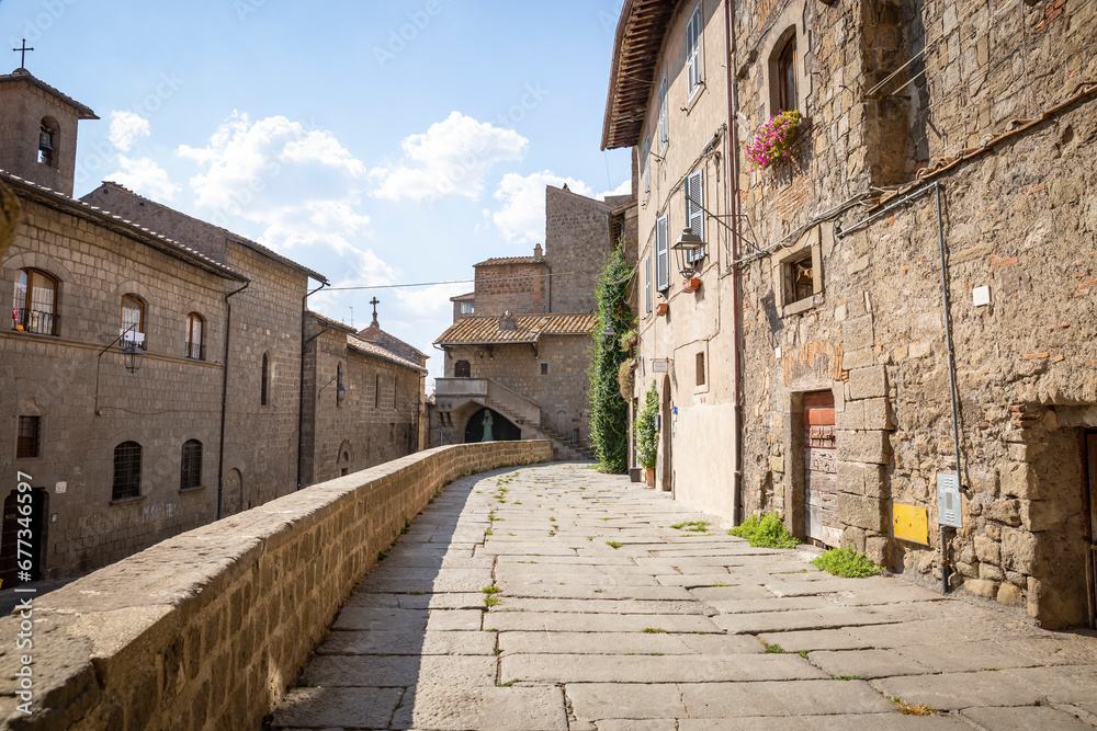 a street with traditional old houses in the medieval old town of Viterbo, Lazio, Italy