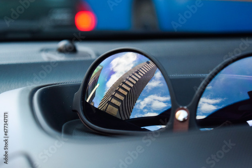 Building reflected in shades during traffic