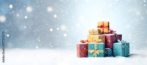 A Stack of Colourful Christmas Gift Boxes with Snowy Winter Background and Copy Space