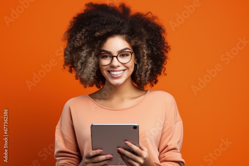 Gen Z individual with digital tablet isolated on a vibrant coral gradient background 