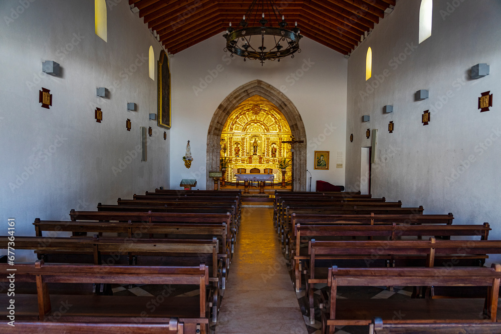 Centered and symmetrical image of the interior of the Catholic church in the Algarve region of Aldeia da Luz.