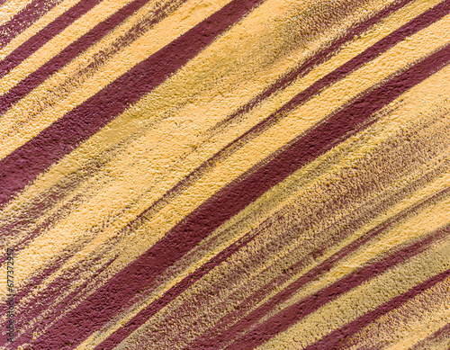 Colorful abstract brush strip drawing on the walls of the city. Striped pattern for wallpaper design. Beautiful bright colorful street art graffiti background.