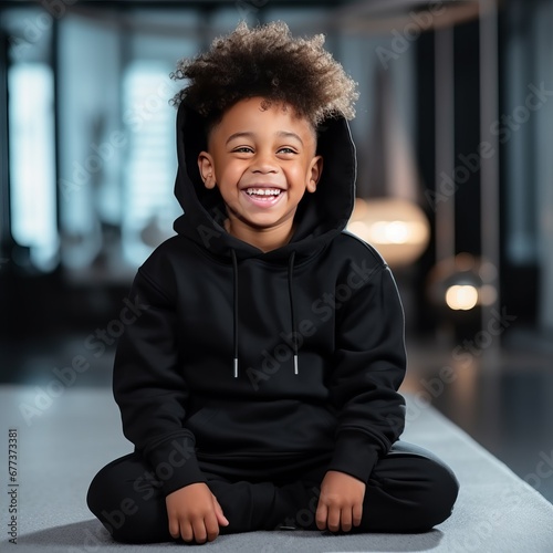Smiling Boy Wearing a Black Hoodie Mockup: Stylish Young Boy Wearing Blank Hoodie, High-Quality Fashion Mockup © StockGeniusPro