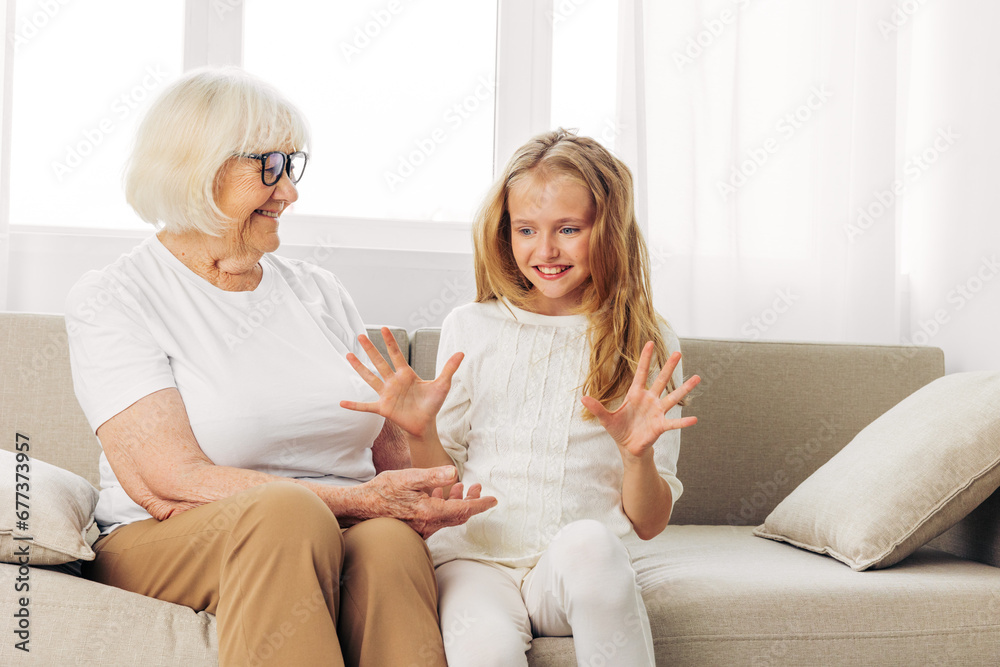 Girl woman love home sofa couch happy child granddaughter family grandmother old elderly Girl woman love home sofa couch happy child granddaughter family grandmother old elderly
