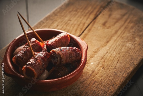 Closeup shot of bacon wrapped mini sausages in a bowl