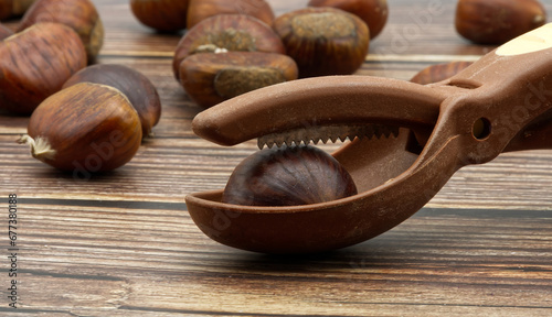 Fresh raw chestnuts isolated on wooden table.