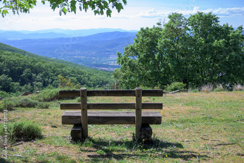 Wooden bench with relaxing views of the nature landscape and mountains horizontally