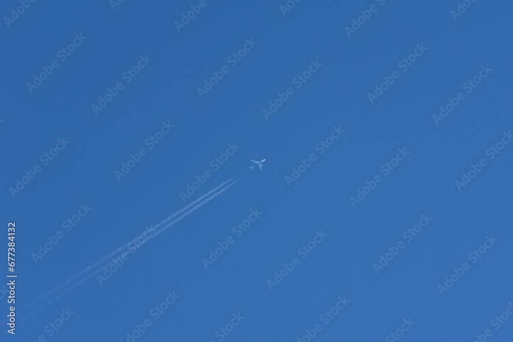 Closeup shot of a white plane flying in the air Closeup shot of a white plane flying in the air