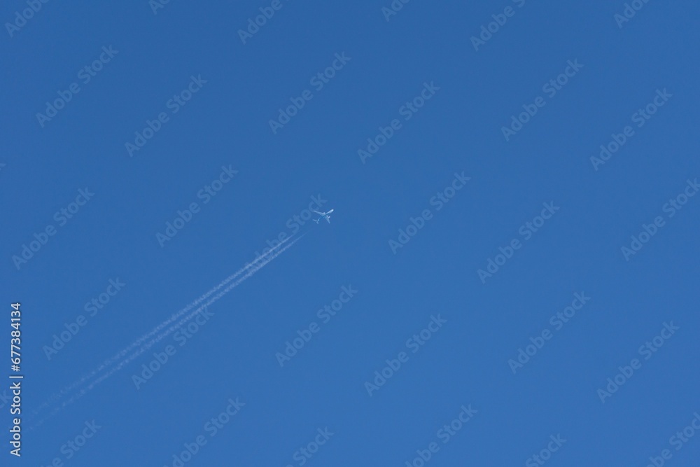Closeup shot of a white plane flying in the air Closeup shot of a white plane flying in the air