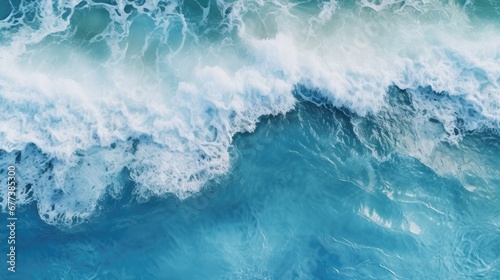 Scenic overhead view of crashing waves in the deep blue ocean, accentuated by the frothy, white foam, capturing the dynamic beauty of the sea in motion.