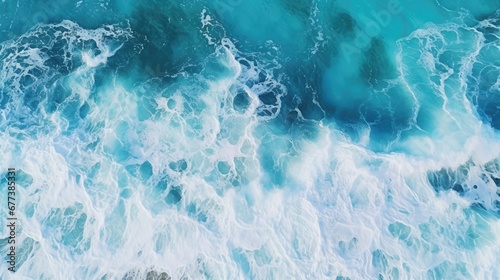 Scenic overhead view of crashing waves in the deep blue ocean, accentuated by the frothy, white foam, capturing the dynamic beauty of the sea in motion.