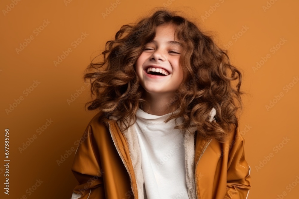 Portrait of a cute little girl with curly hair over brown background Portrait of a cute little girl with curly hair over brown background