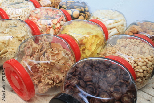 a row of various snacks in jars on the table photo