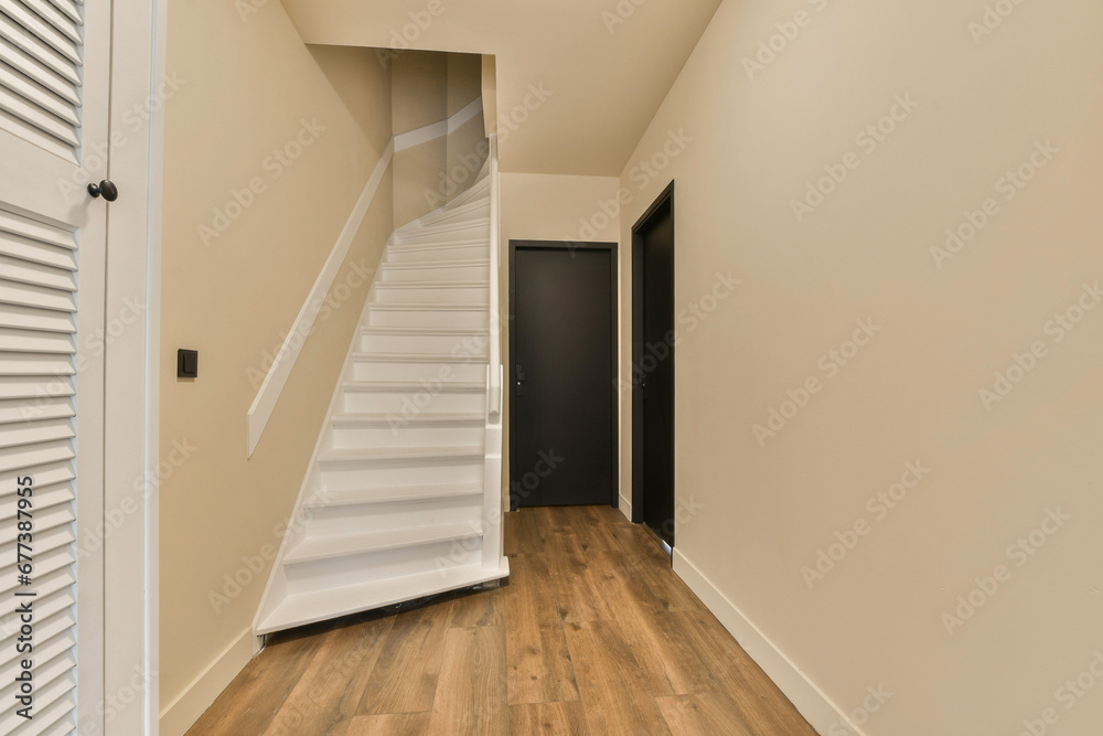 Fototapeta premium an empty room with wooden floors and white shutters on the walls, there is a staircase leading up to the second floor