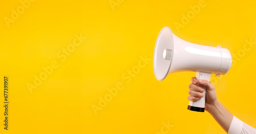 hand hold megaphone empty banner background