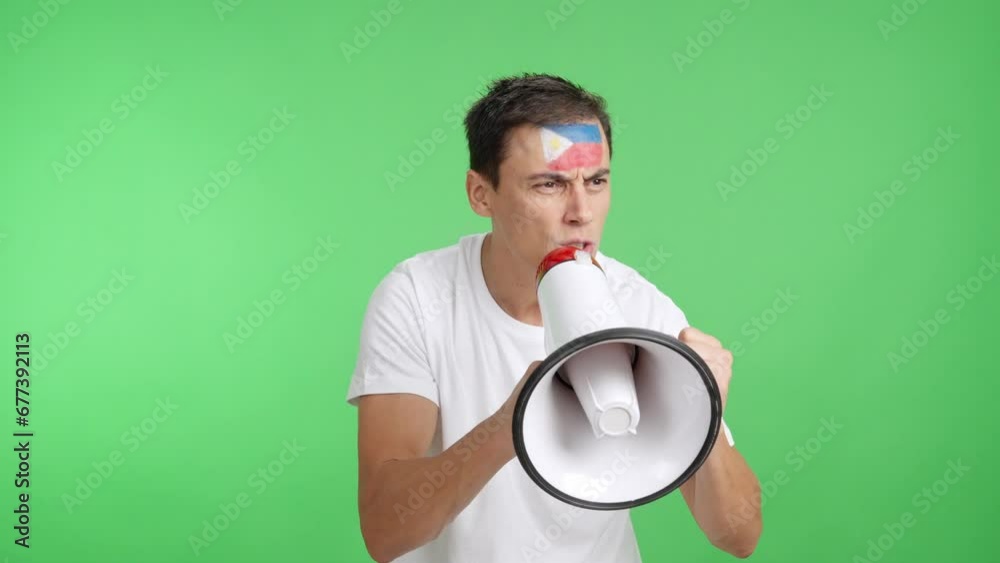 Excited man with philippine flag on face using a megaphone Excited man with philippine flag on face using a megaphone