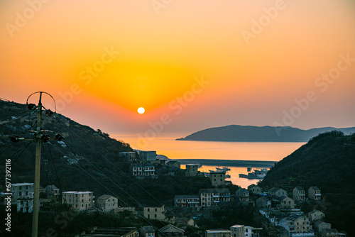 Xiaoruo Village, Wenling City, Taizhou City, Zhejiang Province - sea view and fishing village at sunrise photo